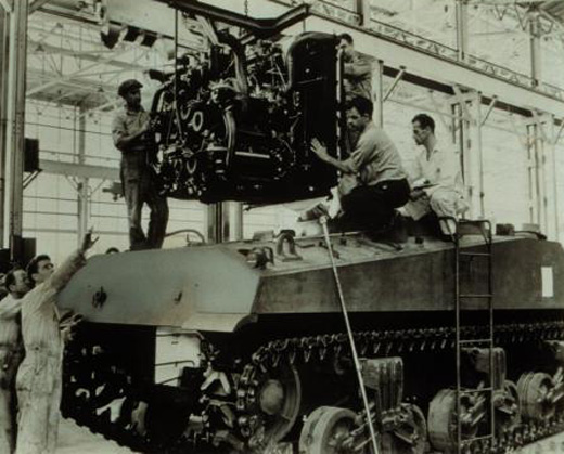 Installation of a multibank tank engine in Sherman M4A3 tanks at Chrysler Tank Arsenal, Warren, Mich., about 1942.